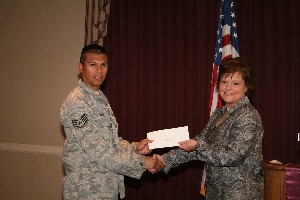 Chapter Vice President for Special Projects Renee Taylor (r), chief, plans and programs, Communications Directorate, 72nd Air Base Wing, presents an enlisted scholarship to Staff Sgt. Jose Teran, USAF, 34th Combat Communications Squadron, 3rd Combat Communications Group, at the April chapter meeting.  